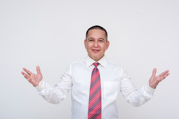 A confident middle aged asian man raising his hands up making assurances. Making an explanation. Isolated on a white background.