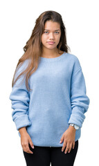 Young beautiful brunette woman wearing blue winter sweater over isolated background skeptic and nervous, frowning upset because of problem. Negative person.