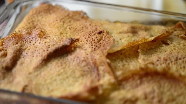 Close-up video pan of Timballo: layers of crepes, artichokes, meat, cheese, B&eacute;chamel sauce, from Abruzzo, Italy.