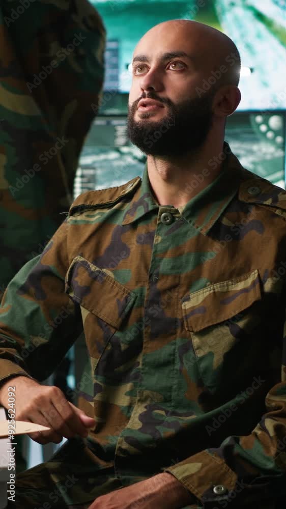 Poster vertical video military agent using augmented reality tech in control room, analyzing aerial reconna