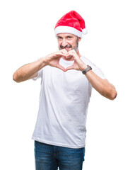 Middle age hoary senior man wearing christmas hat over isolated background smiling in love showing heart symbol and shape with hands. Romantic concept.