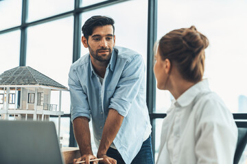 Obraz premium Professional diverse architect engineer team working together to design house model. Group of successful business team discussing and brainstorming about house structure. Civil engineering. Tracery.