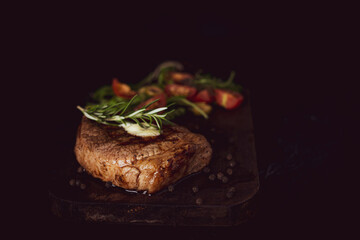 Roast pork with salad on black background