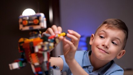 Young boy building robot from plastic bricks