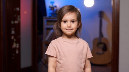 Portrait of smiling girl standing in living room