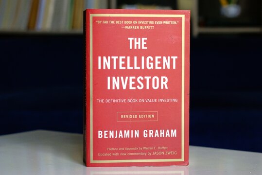 The Intelligent Investor book on a table, value investor book written by Benjamin Graham. Yogyakarta, Indonesia - July 22, 2024