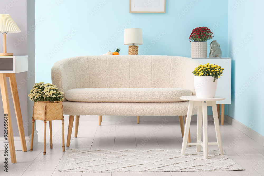 Wall mural interior of modern living room with white sofa and beautiful chrysanthemum flowers