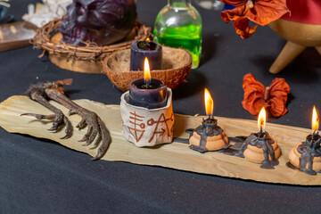 Black magic candles witchcraft composition. Magic ritual satanic tools and items. Halloween and occult black magic ritual imaginary. Ritual scene in dark and frightening atmosphere.