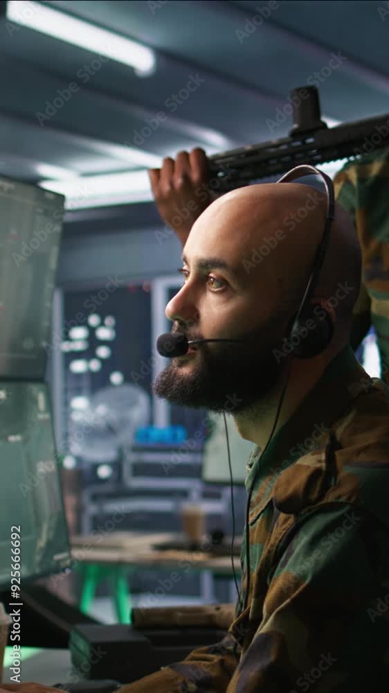 Poster vertical video army specialist working in war room operating surveillance tech, evaluating target da
