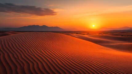 Sunset over desert dunes, golden sand, deep orange sky, soft shadows, distant mountains, serene landscape, warm colors, soft light, tranquil atmosphere, minimalist composition, expansive view.