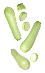 Fresh raw zucchinis falling on white background, whole and slices