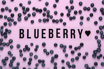 Word BLUEBERRY with sweet fresh berries on lilac background