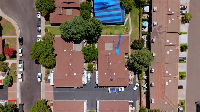 The aerial image highlights a clear termite treatment area with visible roof wraps, underscoring the need for ongoing pest control in the neighborhood and the effectiveness of such efforts