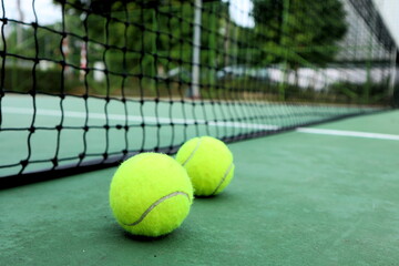 tennis ball on the court with a net background.  Sport and healthy lifestyle