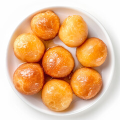 a white bowl filled with doughnuts on top of a white table