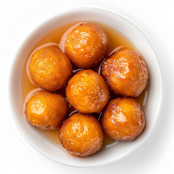 a bowl of glazed donuts with syrup