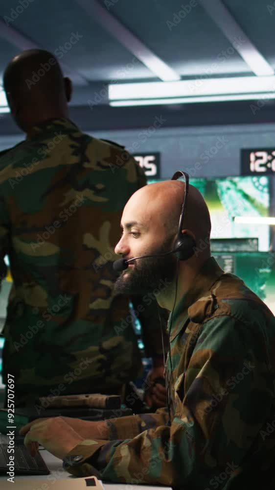 Poster vertical video soldier solving tasks in military hq base, gathering information on enemy troops. mid