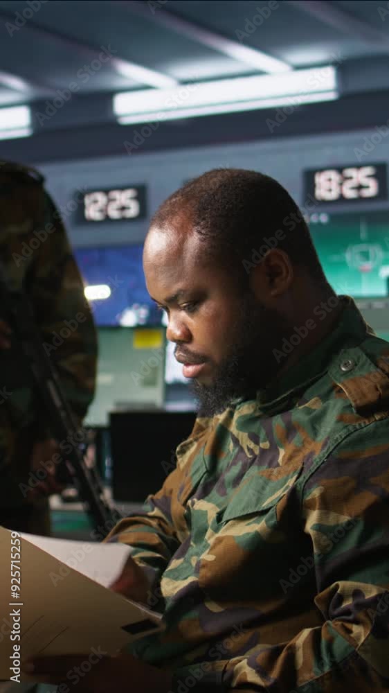 Poster vertical video military officer in command post receiving intel folder files on enemy battle formati