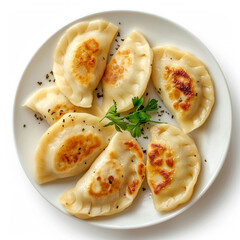 a plate of dumplings with a sprig of parsley