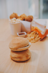 fast food, people and unhealthy eating concept - close up of woman hands holding hamburger or cheeseburger