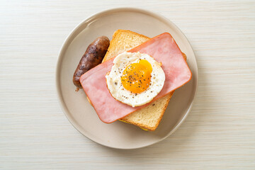 bread toasted cheese topped ham and fried egg with pork sausage
