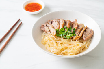 dried noodles with stewed duck in white bowl