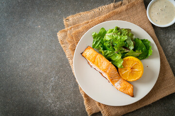 fried salmon steak with lemon and vegetable
