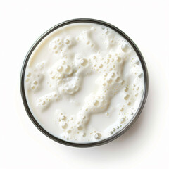 a glass of milk with bubbles on top