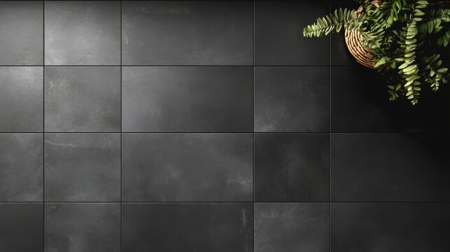 Top view of a contemporary tile pattern with large rectangular tiles in a matte black finish, laid out in a grid on a bathroom floor