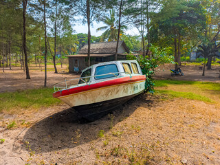 Abandoned used boats on the beach area during the day