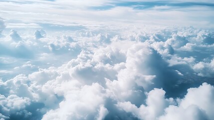 A breathtaking aerial view of fluffy white clouds against a bright blue sky.