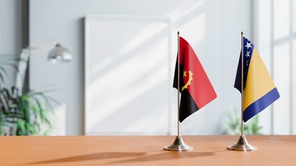 FLAGS OF ANGOLA AND BOSNIA  ON TABLE
