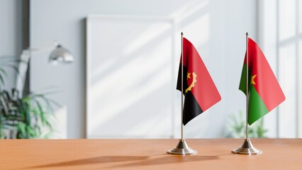 FLAGS OF ANGOLA AND BURKINA-FASO  ON TABLE