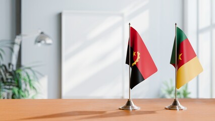 FLAGS OF ANGOLA AND CAMEROON  ON TABLE