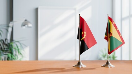 FLAGS OF ANGOLA AND GRENADA  ON TABLE