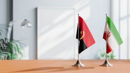 FLAGS OF ANGOLA AND IRAN  ON TABLE