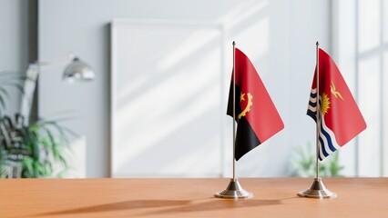 FLAGS OF ANGOLA AND KIRIBATI  ON TABLE