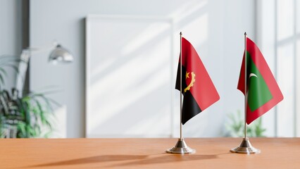 FLAGS OF ANGOLA AND MALDIVES  ON TABLE