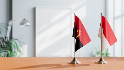 FLAGS OF ANGOLA AND MONACO  ON TABLE