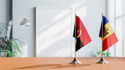 FLAGS OF ANGOLA AND MOLDOVA  ON TABLE