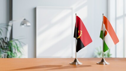 FLAGS OF ANGOLA AND NIGER  ON TABLE