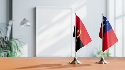 FLAGS OF ANGOLA AND SAMOA  ON TABLE