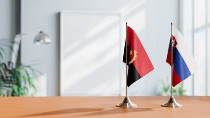 FLAGS OF ANGOLA AND SLOVAKIA  ON TABLE