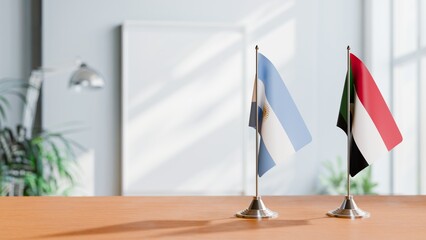 FLAGS OF ARGENTINA AND SUDAN  ON TABLE