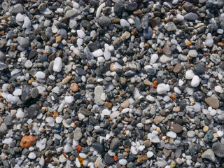 Background of colorful pebbles on the sand beach