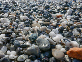 Background of colorful pebbles on the sand beach