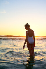 Fototapeta premium Girl, thinking and ocean sunset for swimming in outdoor, swimsuit and wonder on weekend trip. Female person, tropical island and nature for mindfulness or wellness on travel, peace and holiday dusk