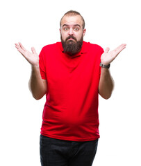Young caucasian hipster man wearing red shirt over isolated background clueless and confused...