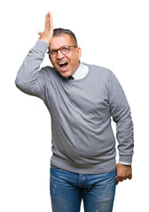 Middle age bussines arab man wearing glasses over isolated background surprised with hand on head for mistake, remember error. Forgot, bad memory concept.