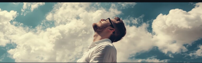 High school boy gazing thoughtfully at the sky on a sunny day